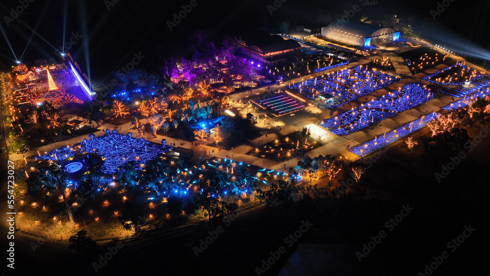 Fototapeta premium Aerial drone night distant shot from illuminated with Christmas lights futuristic Ellinikon Experience public Park an urban regeneration project and cultural center in Athens riviera, Attica, Greece