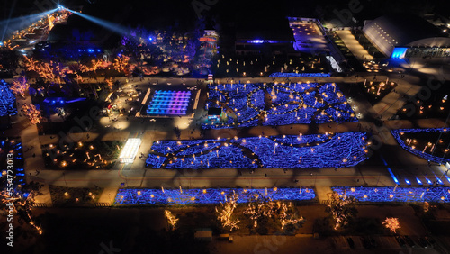 Aerial drone night distant shot from illuminated with Christmas lights futuristic Ellinikon Experience public Park an urban regeneration project and cultural center in Athens riviera, Attica, Greece © aerial-drone