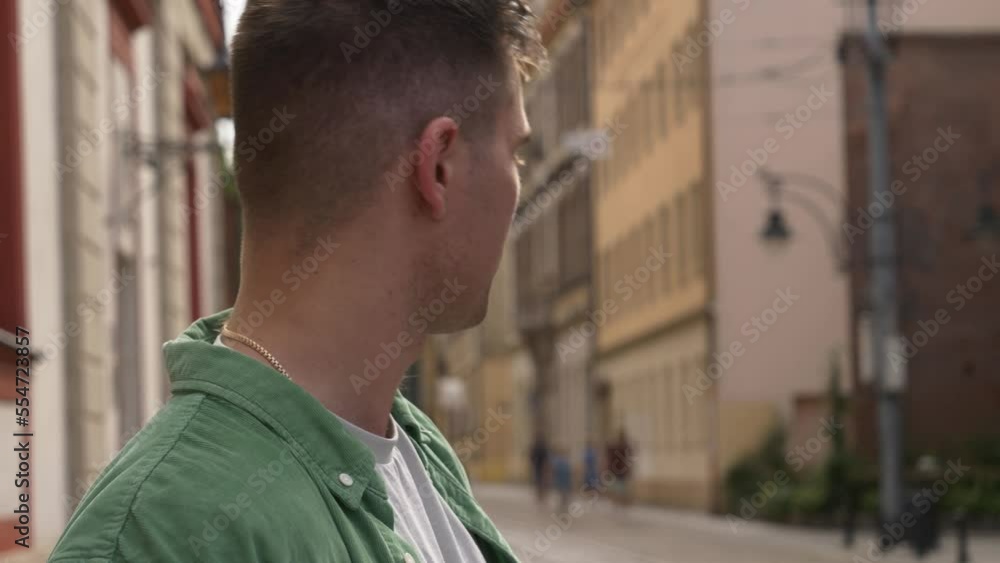 Stylish guy in green shirt with mobile phone on city street Stylish guy in green shirt with mobile phone on city street