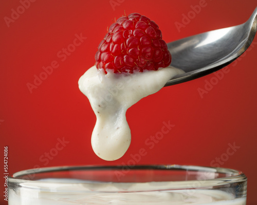 raspberry on a spoon with yogurt