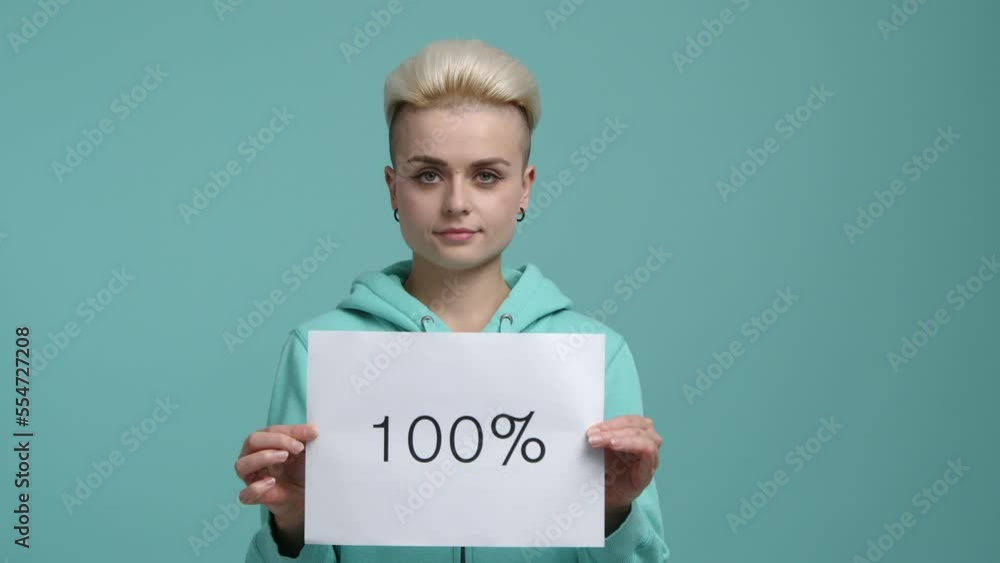 Close-up shot of a young girl with positive facial expression. Stylish woman with short haircut holding a card with numbers and symbols. High quality 4k footage Close-up shot of a young girl with positive facial expression. Stylish woman with short haircut holding a card with numbers and symbols. High quality 4k footage