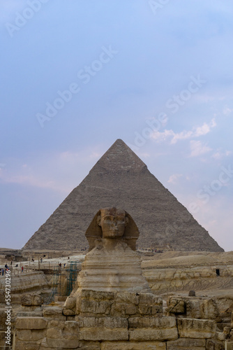 The Sphinx seen from the front, with Khaphren's pyramid just behind, with the sky full of clouds