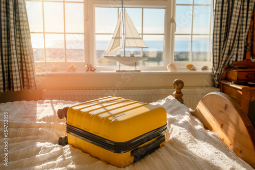 Suitcase or luggage bag in a classic old hotel room with sea view photo