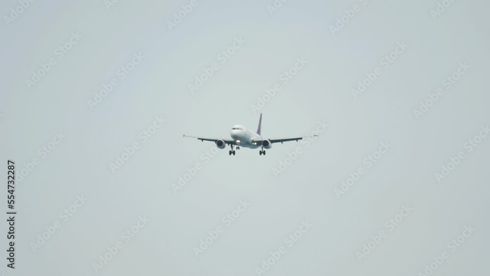Long shot, jet plane released landing gear, approaching to land. Tourism and travel concept Long shot, jet plane released landing gear, approaching to land. Tourism and travel concept