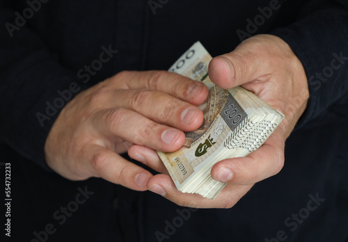 stack of large banknotes in the hands of a man. selective focus