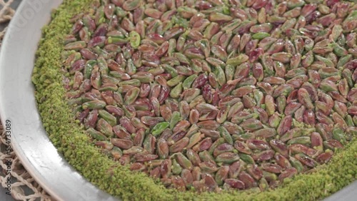 Traditional Turkish dessert kunefe in the copper plate. Kanafeh concept with cheese and pistachio 
 photo