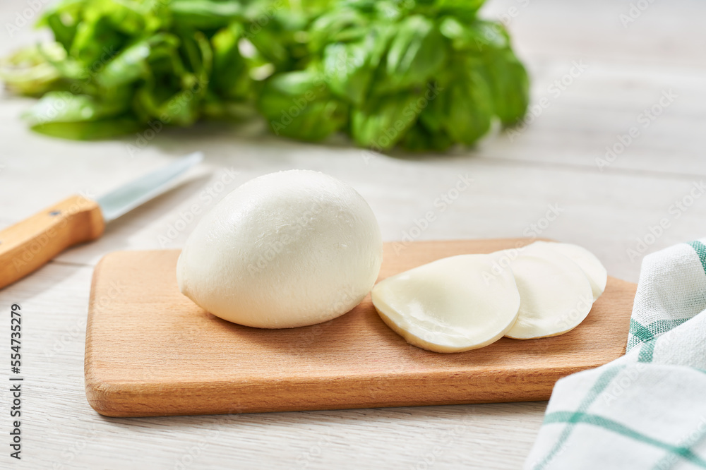 soft Italian cheese mozzarella buffalo on a kitchen table. soft Italian cheese mozzarella buffalo on a kitchen table.