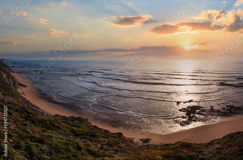 Evening summer ocean view over Carriagem beach at low tide (Aljezur, Algarve, Portugal).