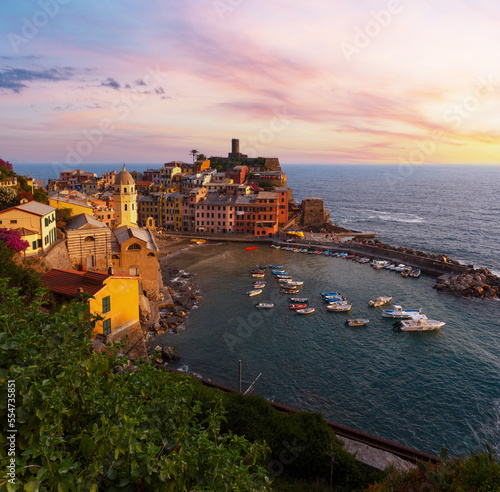 Beautiful sunset in summer Vernazza - one of five famous villages of Cinque Terre National Park in Liguria, Italy, suspended between Ligurian sea and land on sheer cliffs.