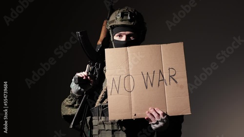 Military soldier holds a NO TO WAR sign, the horror of war. mass media, news, Russian-Ukrainian war. photo