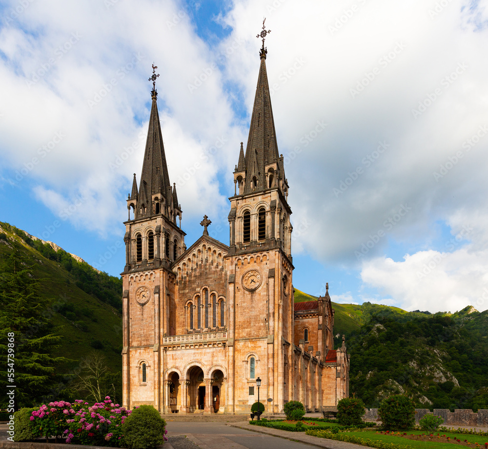 View of majestic neo-romanesque temple - Basilica of Blessed Virgin Mary in valley of Covadonga, Asturias, Spain..