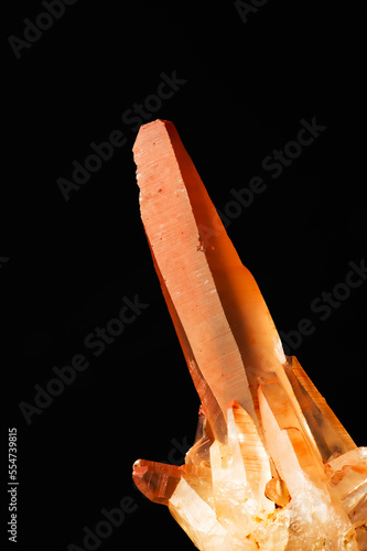 Hematoid Quartz crystal macro detail black isolated background. close-up rough raw unpolished semi-precious gemstone. photo