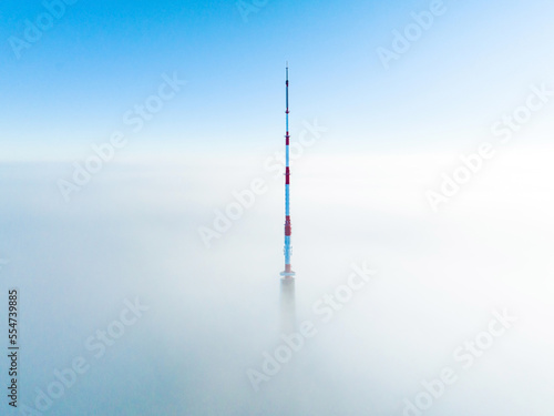 Aerial drone top view of the Riga TV Tower in Latvia. Highest TV tower in Europe over the clouds.