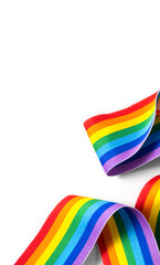 Colorful rainbow ribbon border design. LGBT colourful corner design, isolated on white background. Gay pride design. Curly, waving ribbon or banner with flag of LGBTQ pride border. Vertical image