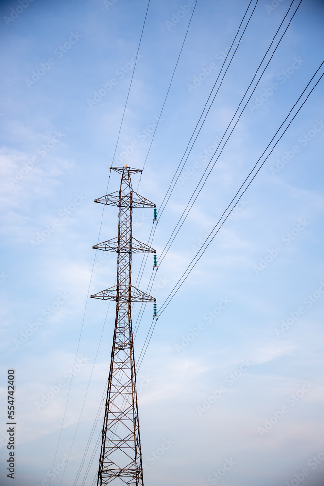 Power lines and electric tower with blue sky and clouds on background. Power lines and electric tower with blue sky and clouds on background.