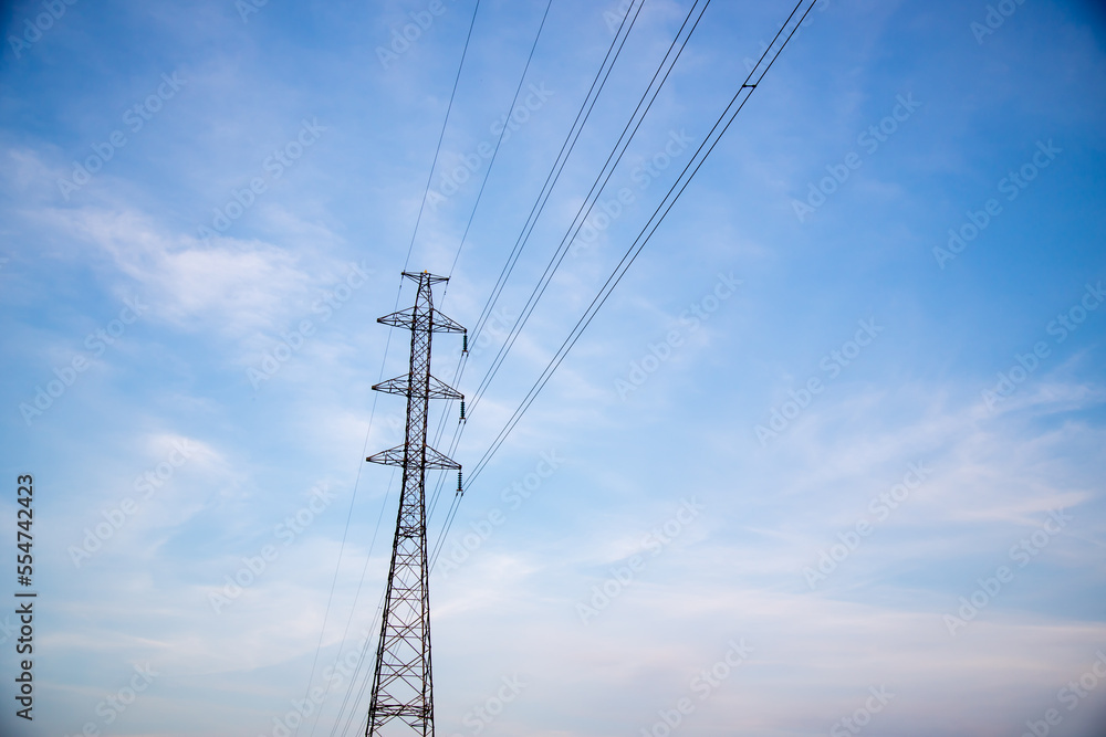 Power lines and electric tower with blue sky and clouds on background. Power lines and electric tower with blue sky and clouds on background.