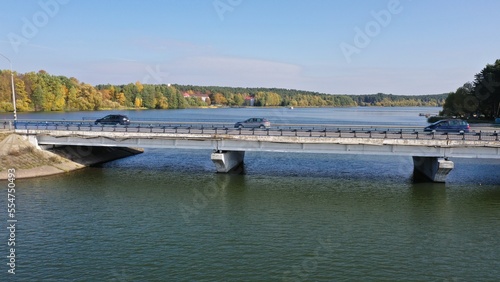 Zhdanovichi, Belarus - 01.10.2022: Bridge across the Drozdy reservoir near Minsk. Cars drive over the bridge. Bridges of Belarus. Recreational zone Zhdanovichi near Minsk.
