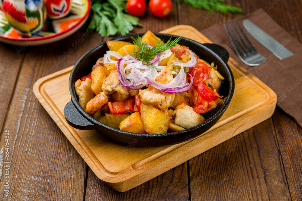 Fried Chicken, potatoes and vegetables on old wooden table Fried Chicken, potatoes and vegetables on old wooden table