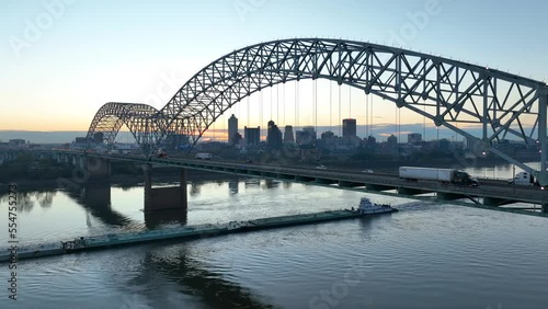 Memphis Tennessee skyline framed in Hernando de Soto bridge. Barge on Mississippi River. Aerial establishing shot. photo