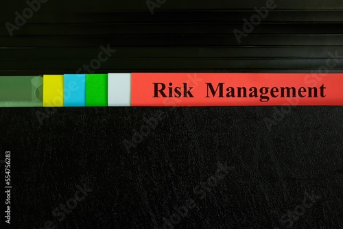 Risk management file record in black binder folder. Risk management business concept. 