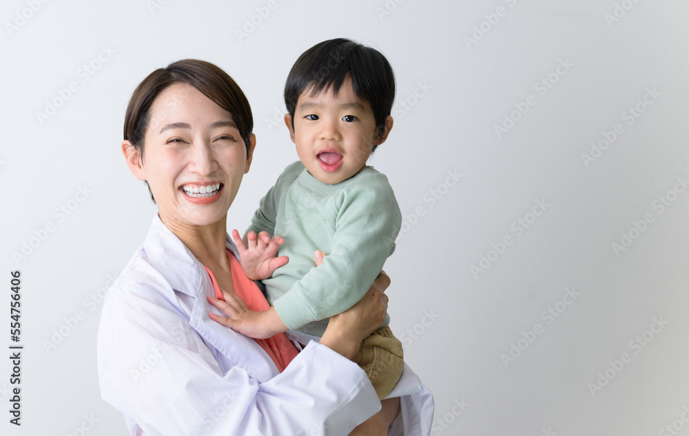 Image of a female doctor working while raising a child Looking at the camera Image of a female doctor working while raising a child Looking at the camera