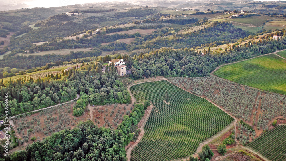 A vineyard with a large home on the property, as seen from a hot air balloon over Tuscany, Italy.