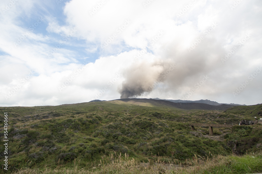 Beautiful Panorama Aerial View Smoke Gas Steam Crater of Mount Aso Volcano Caldera largest active Volcano in Japan eruption under Sunny Clear Blue Sky in Summer Daytime, Kumamoto, Kyushu