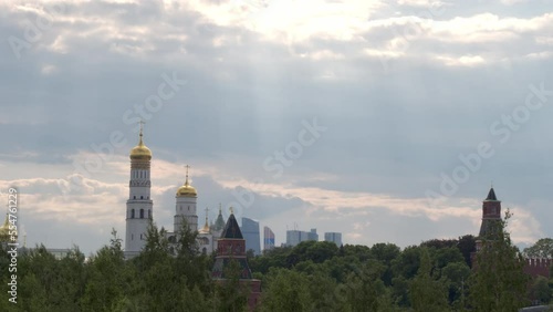 Magnificent view of the white building of the Ivan the Great bell tower and the Kremlin watchtowers against the cloudy sky over Moscow.