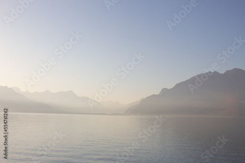 Panoramic view of Lake Leman or Lake of Geneva with morning mist over the water surface. Copy space