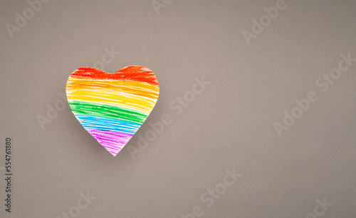 A rainbow heart made from paper on a gray background © meeboonstudio