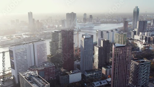 Residential Skyscraper The Red Apple Surrounded By High-rise Towers On Wijnhaven Island In Rotterdam, Netherlands. aerial pullback photo