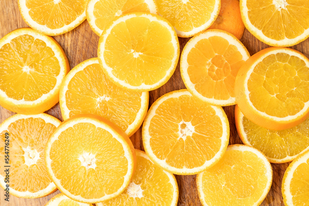 Juicy oranges on a background of ice cubes with copy space on a blue background Juicy oranges on a background of ice cubes with copy space on a blue background