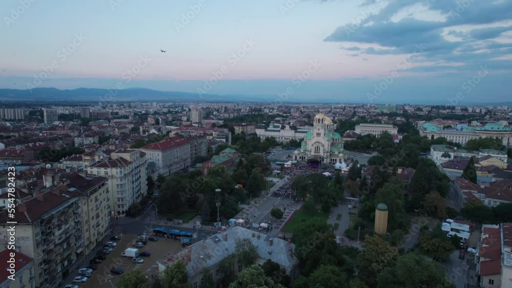 Aerial drone ascent revealing airplane flying over St. Alexander Nevsky Cathedral in Sofia at sunset Aerial drone ascent revealing airplane flying over St. Alexander Nevsky Cathedral in Sofia at sunset