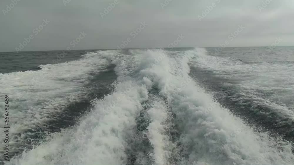 wake of water seen from behind of fast moving motor boat in a clear sky day,Blue sea , water surface. wake of water seen from behind of fast moving motor boat in a clear sky day,Blue sea , water surface.