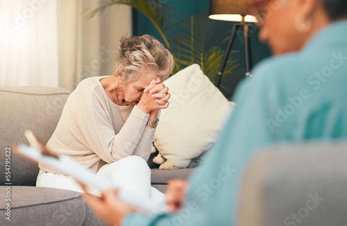 Psychologist, stress or old woman with depression in counseling or therapy crying for support or help. Psychology, anxiety or therapist writing a report for a sad, stressed or frustrated elderly lady