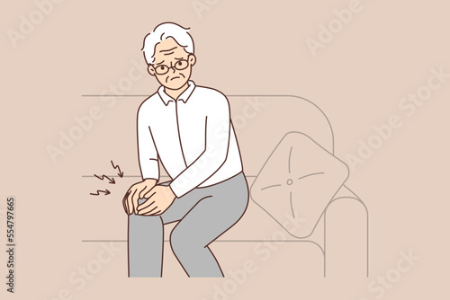 Unhealthy mature man suffer from knee pain 
