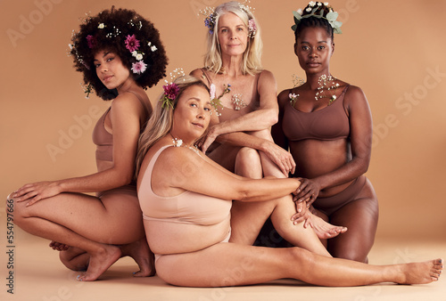 Portrait, flowers and group of women in lingerie in studio isolated on brown background. Floral cosmetics, organic makeup and body positive friends in underwear with plant product for beauty skincare