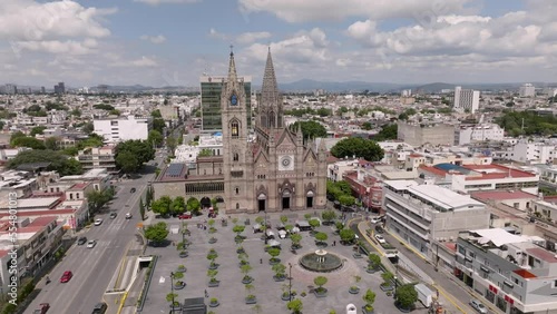Historic Church Templo Expiatorio del Santisimo Sacramento And Expiatorio Park In The City Of Guadalajara In Jalisco, Mexico. aerial pullback photo