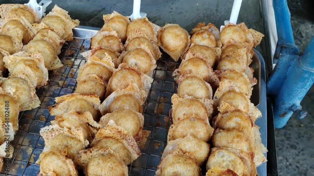Khanom Krok, traditional Thai dessert, made from coconut, coconut milk, and flour, sale on market Khanom Krok, traditional Thai dessert, made from coconut, coconut milk, and flour, sale on market