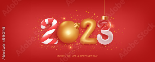 Happy new year 2023 background. Christmas decoration with transparent number filled with snow, on red background with golden confetti. Holiday greeting card design.