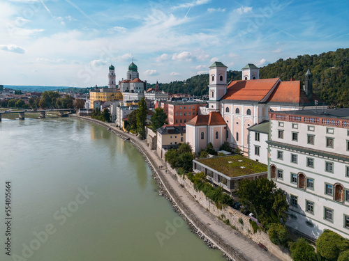 Germany, Bavaria, Passau, Aerial view of Innkai promenade in summer with St. Stephens Cathedral and St. Michaels Church in background photo