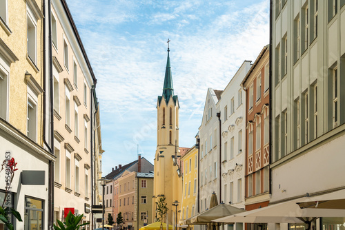 Germany, Bavaria, Passau, Houses along Theresienstrasse with City Parish Church of Saint Matthew in background photo