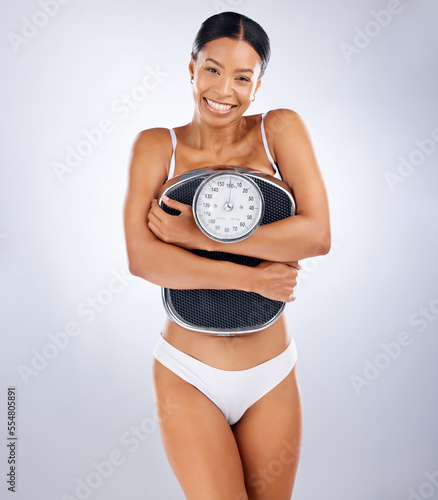 Woman  scale and weight loss portrait with underwear  health and wellness with smile by studio background. Black woman  diet and body goals for fitness  happiness and self care in by studio backdrop
