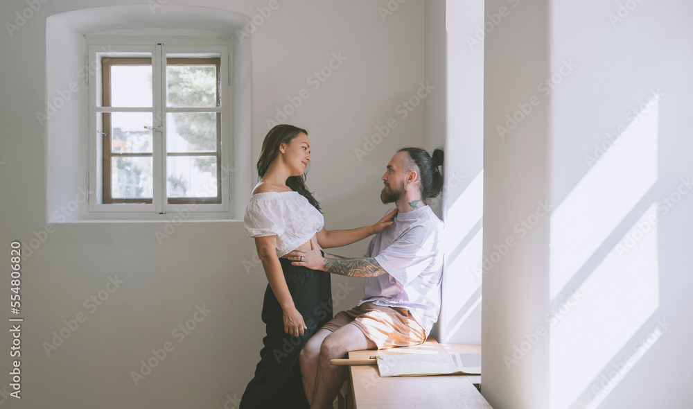Romantic hipster couple by wall at home Romantic hipster couple by wall at home