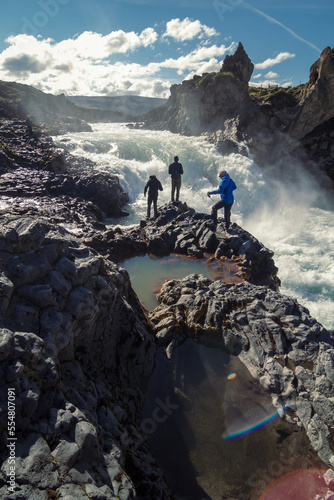 Tourists at Godafoss waterfall landscape photo. Beautiful nature scenery photography with cloudy sky on background. Idyllic scene. High quality picture for wallpaper, travel blog, magazine, article