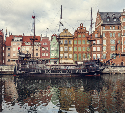 Ship near waterfront in Gdansk cityscape photo. Beautiful urban scenery photography with buildings on background. Street scene. High quality picture for wallpaper, travel blog, magazine, article