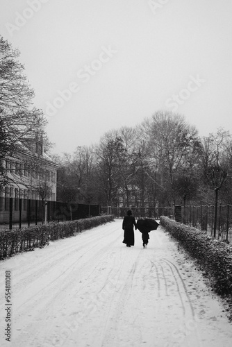 Mother with child walking in Snow at Vienna Augarten photo