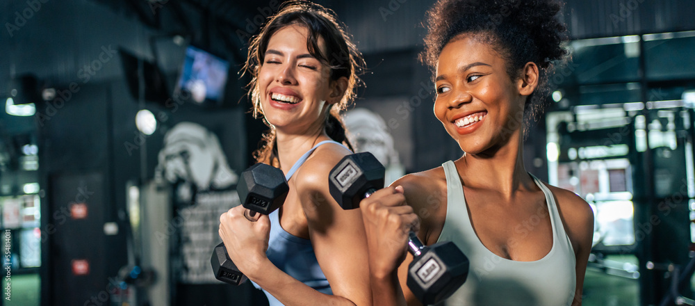 Latino and African sport woman exercising and build muscle in stadium. Latino and African sport woman exercising and build muscle in stadium.