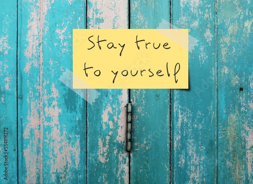 Old vintage blue door background with handwritten text - STAY TRUE TO YOURSELF means to have self awareness, knowing your own values, beliefs, preferences and be who you actually are