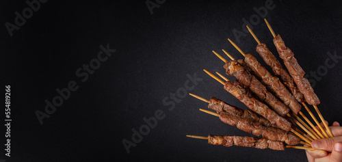 Photos Lamb skewers also called kebabs, or arrosticini or chuan, are small pieces of meat roasted on wooden skewers over charcoal